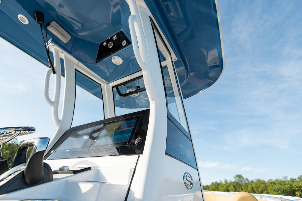 Blue hard-top canopy with white frame structure and electronics mounted on the boat console