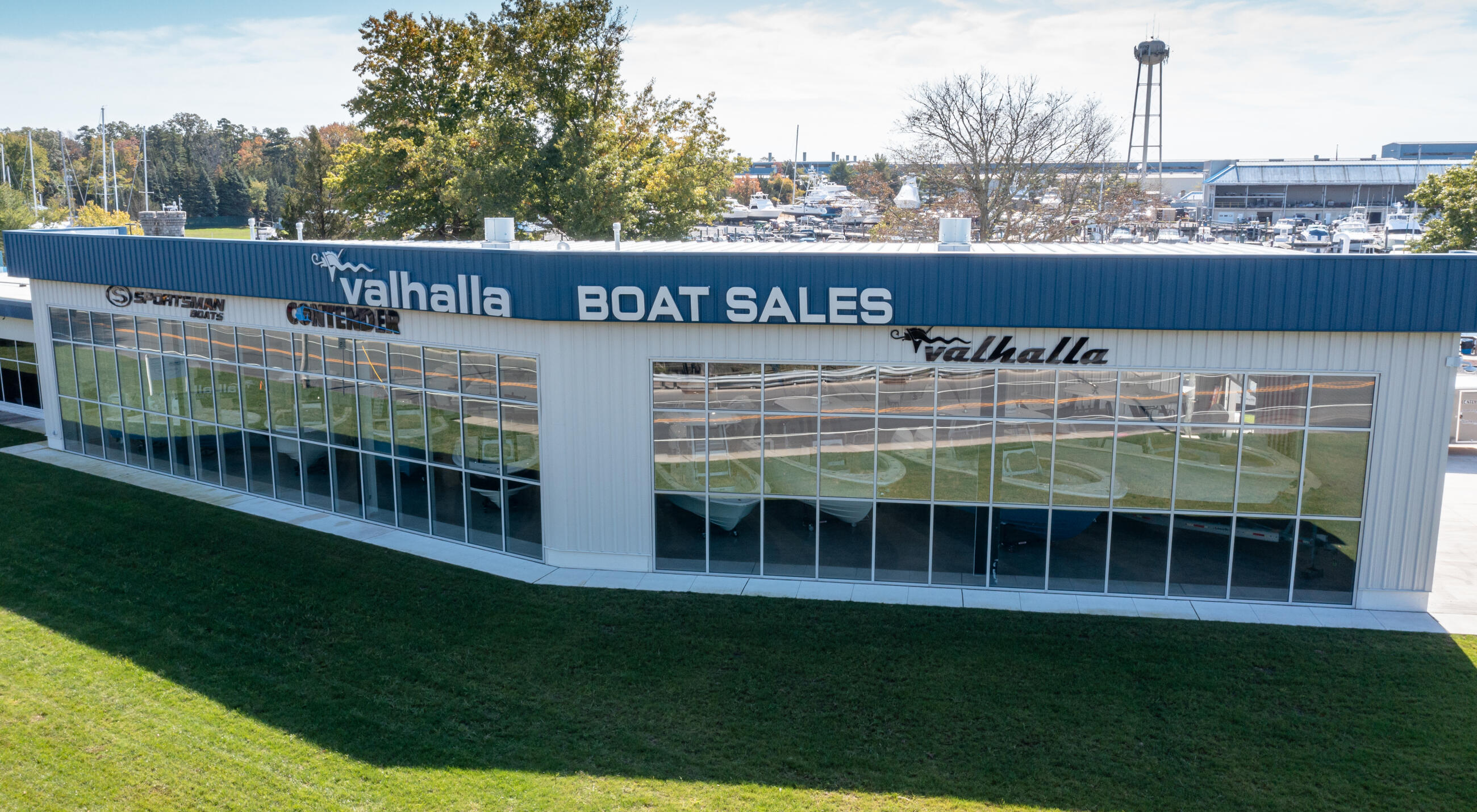 Valhalla Boat Sales dealership storefront with large glass windows overlooking a marina in North New Gretna, New Jersey