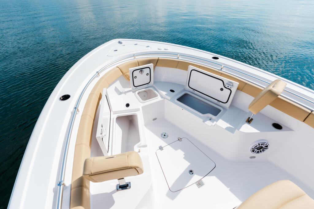 Overhead view of a center console fishing boat helm with tan upholstered seating and white fiberglass cabin