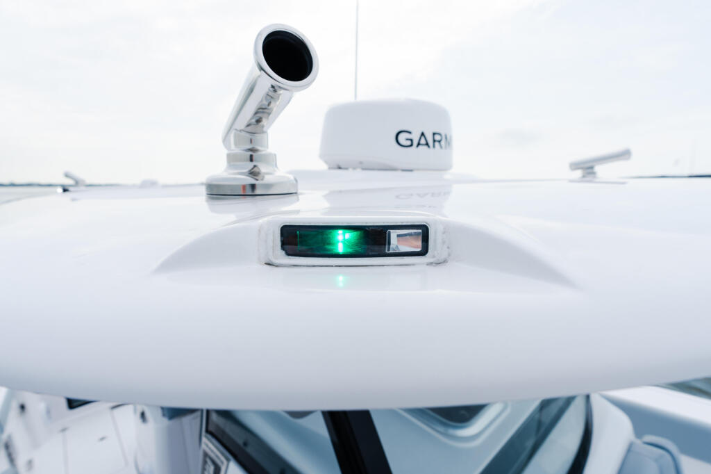 Boat's hardtop electronics including Garmin radar and navigation display with green indicator light