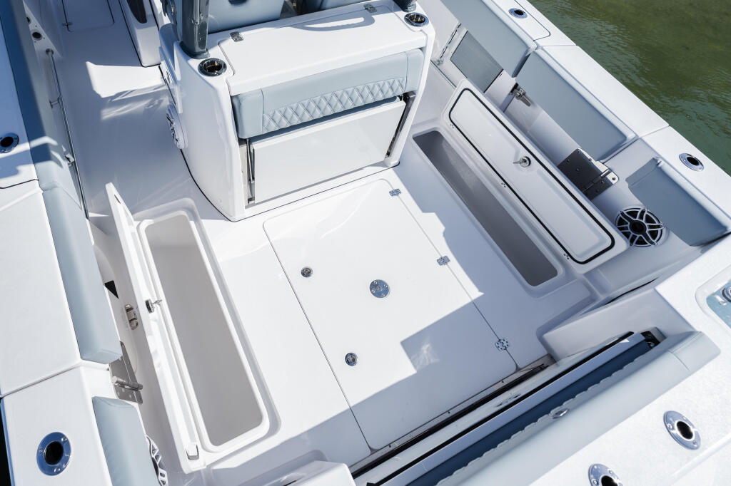 Overhead view of open sportfishing boat cockpit with livewell, storage, and electronics