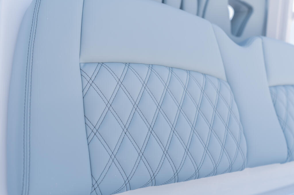 Light gray upholstered boat seat with diamond-pattern quilting detail