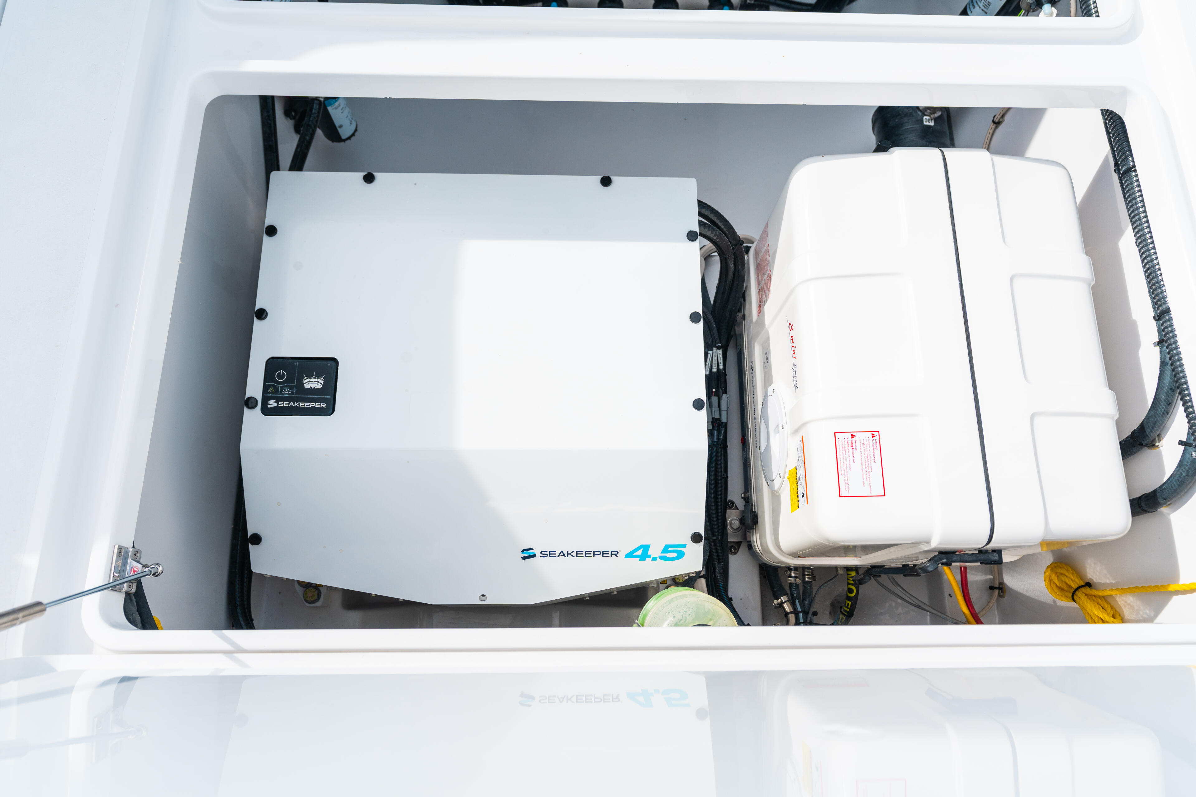Seakeeper 4.5 gyroscope stabilization system installed in boat's engine compartment alongside battery box