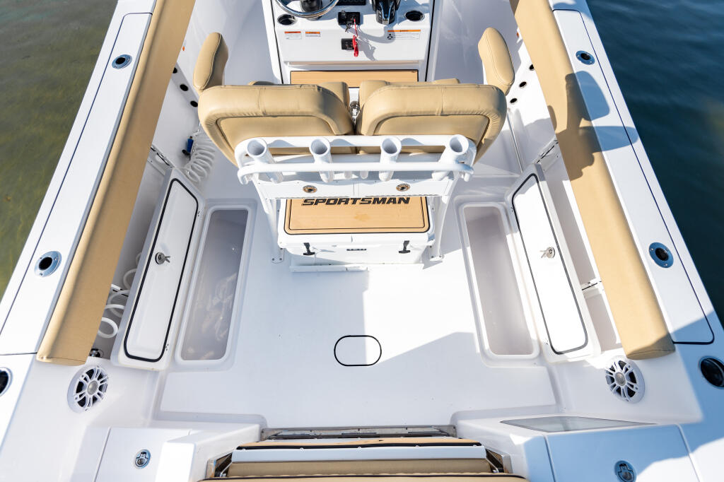 Overhead view of a Sportsman center console boat with tan cushioned seating and white hull featuring storage compartments