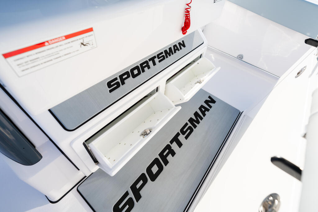 Sportsman boat models with open livewell storage compartments on white gel coat hull