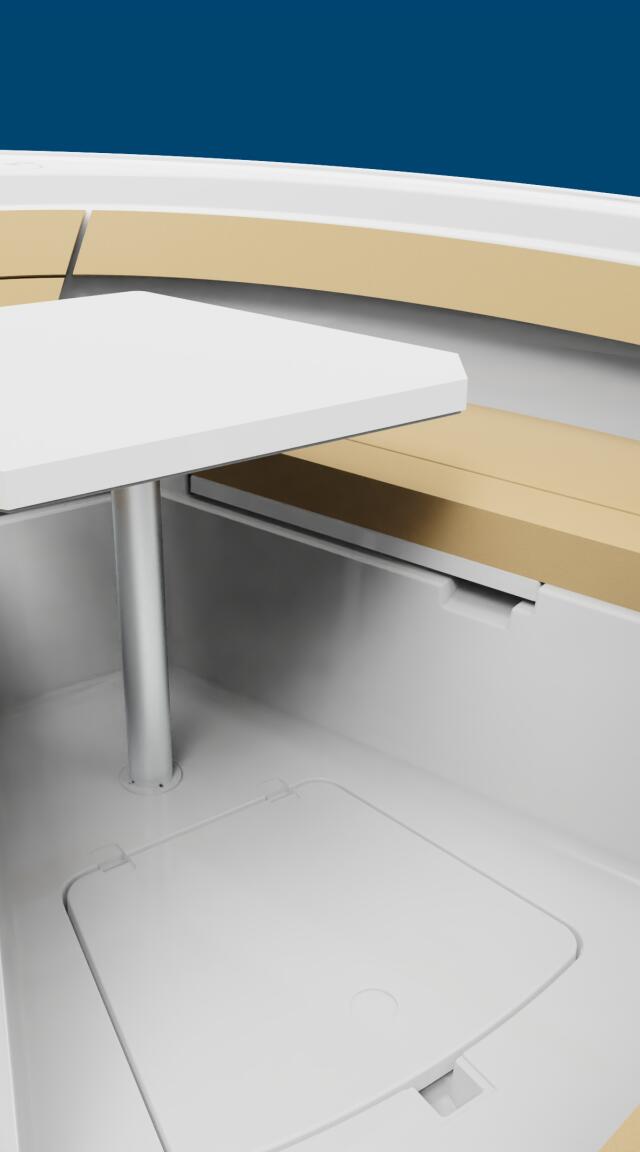 Overhead view of boat cabin interior with tan and white seating, compact table, and storage compartments