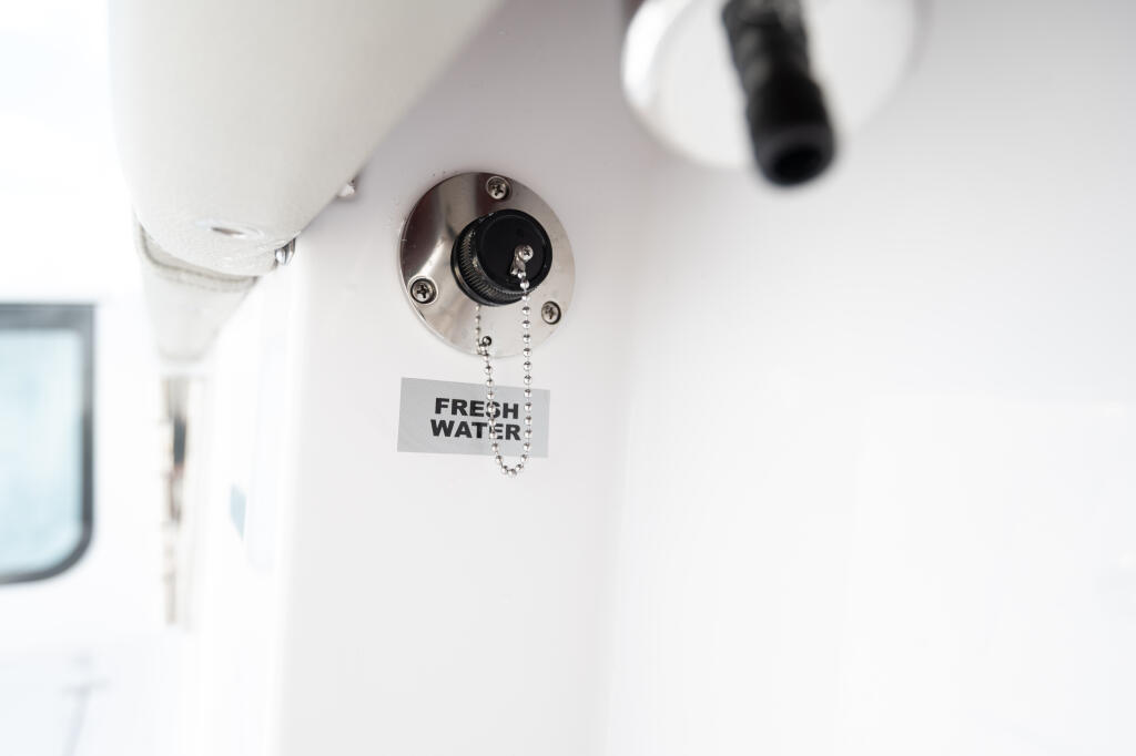 Fresh water washdown valve with pull chain mounted on boat cabin ceiling