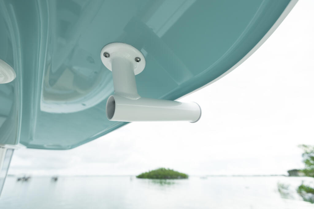 Boat hard-top with white rod holder mounted underneath, viewed from below looking up