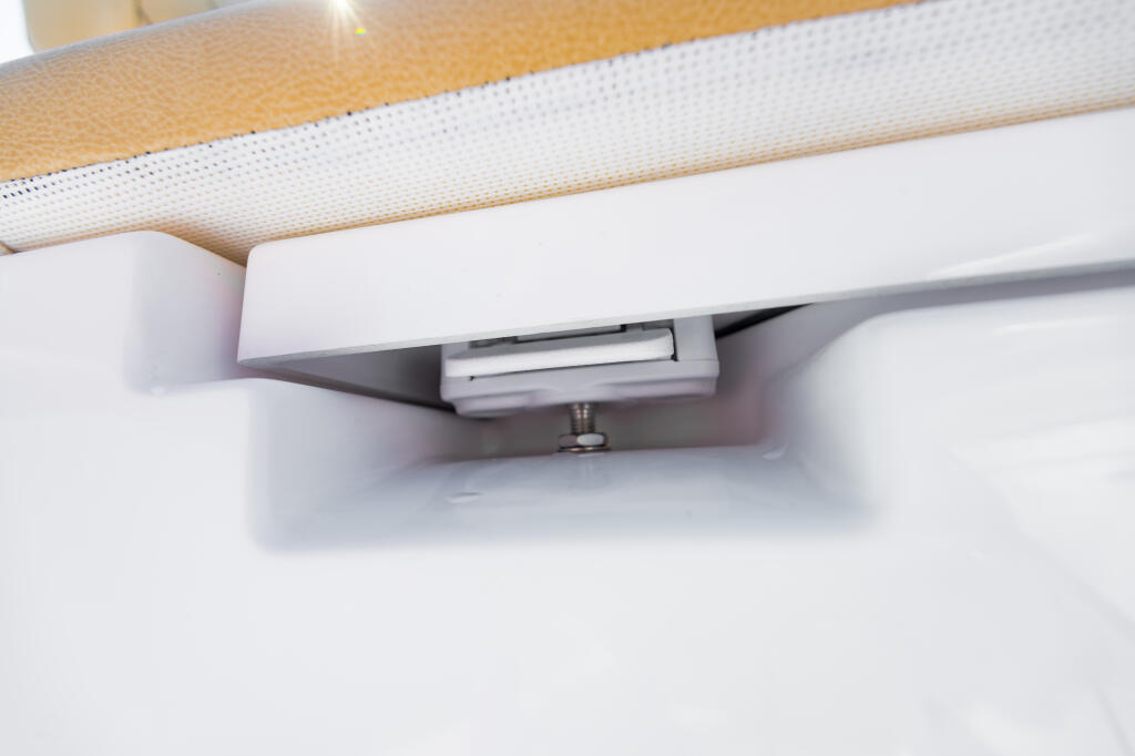 Paddle-style latch mechanism mounted on center console with white housing and stainless hardware