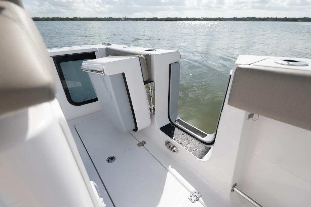 Side-entry cabin doors with 180-degree swing opening on center console boat over shallow water