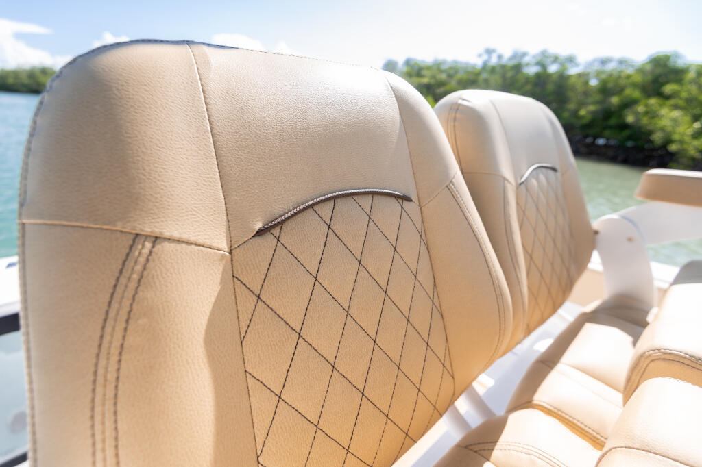 Cream-colored quilted marine seating with diamond stitching pattern on a center console boat