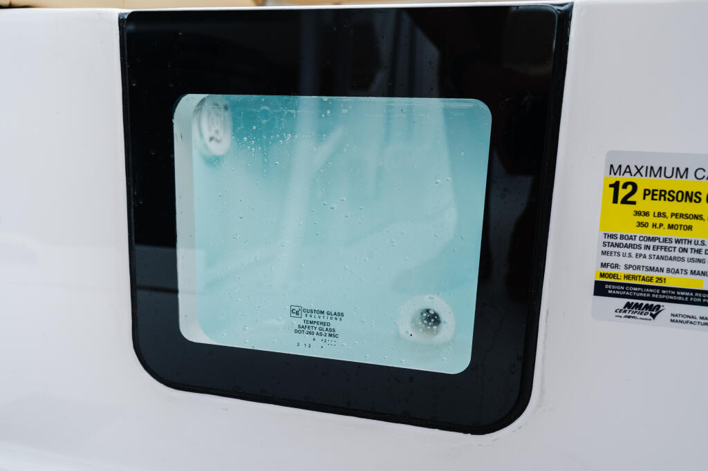 Custom tinted windshield panel with certification labels and maximum capacity rating visible