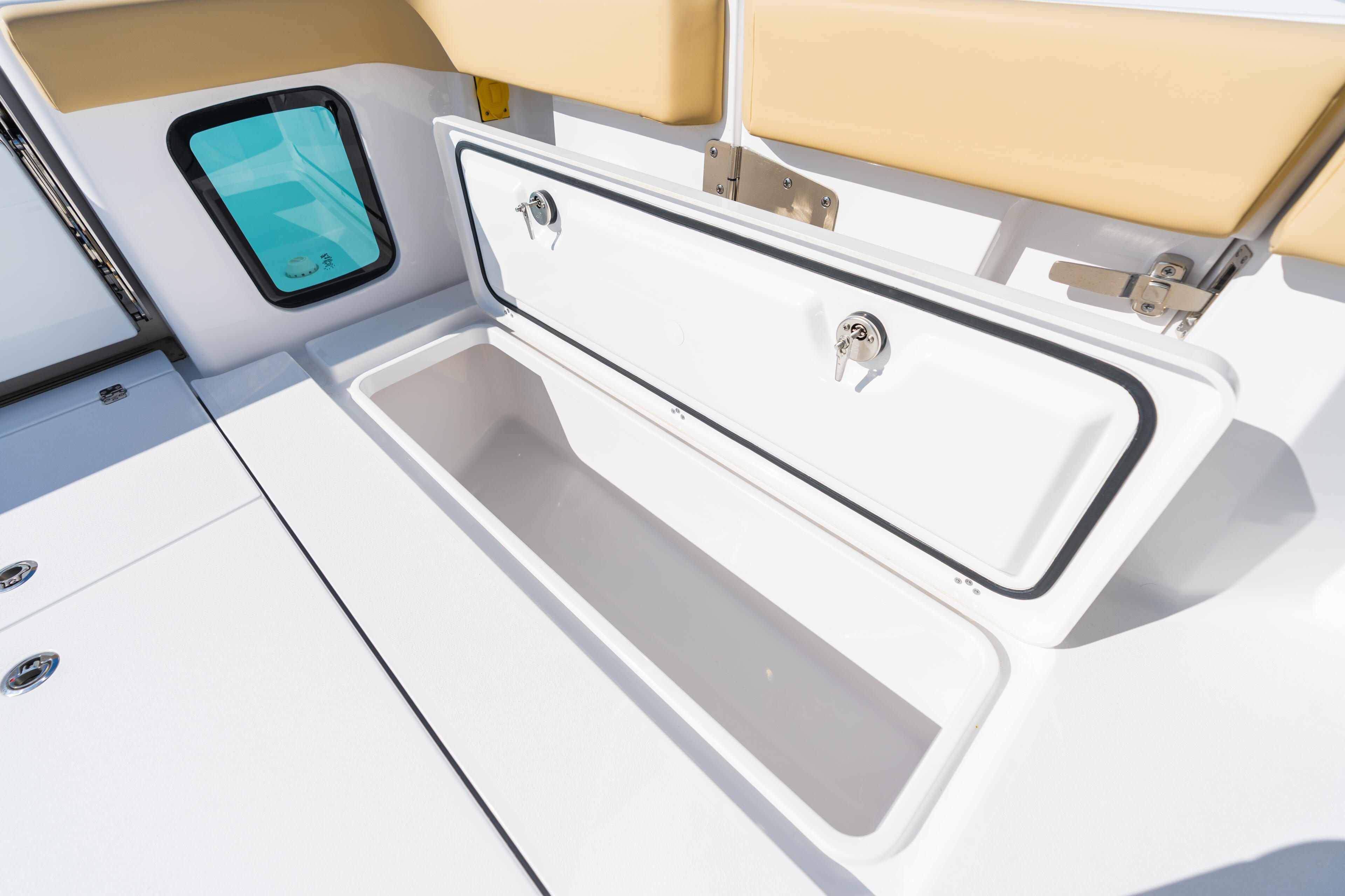 Open in-deck fish boxes with livewell controls and GPS display on center console