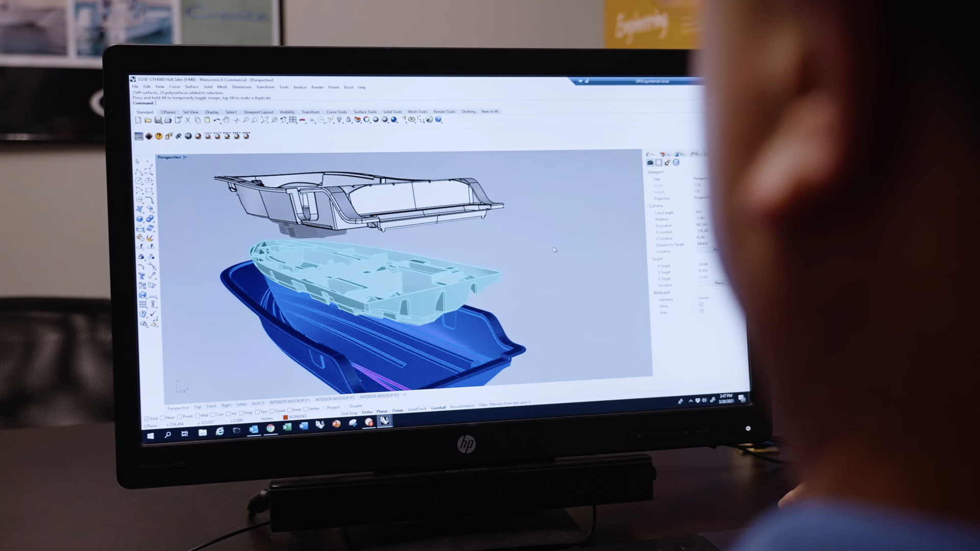 3D CAD model of a boat showing hull design layers displayed on computer monitor