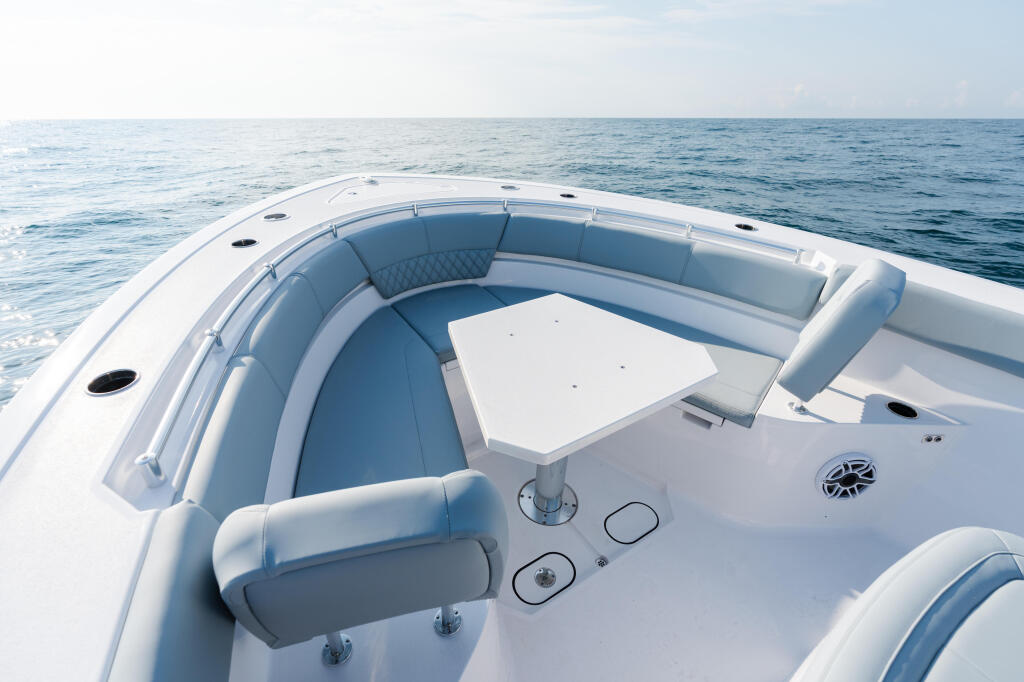 Overhead view of boat's spacious helm and seating area with cushioned seats and controls overlooking open ocean