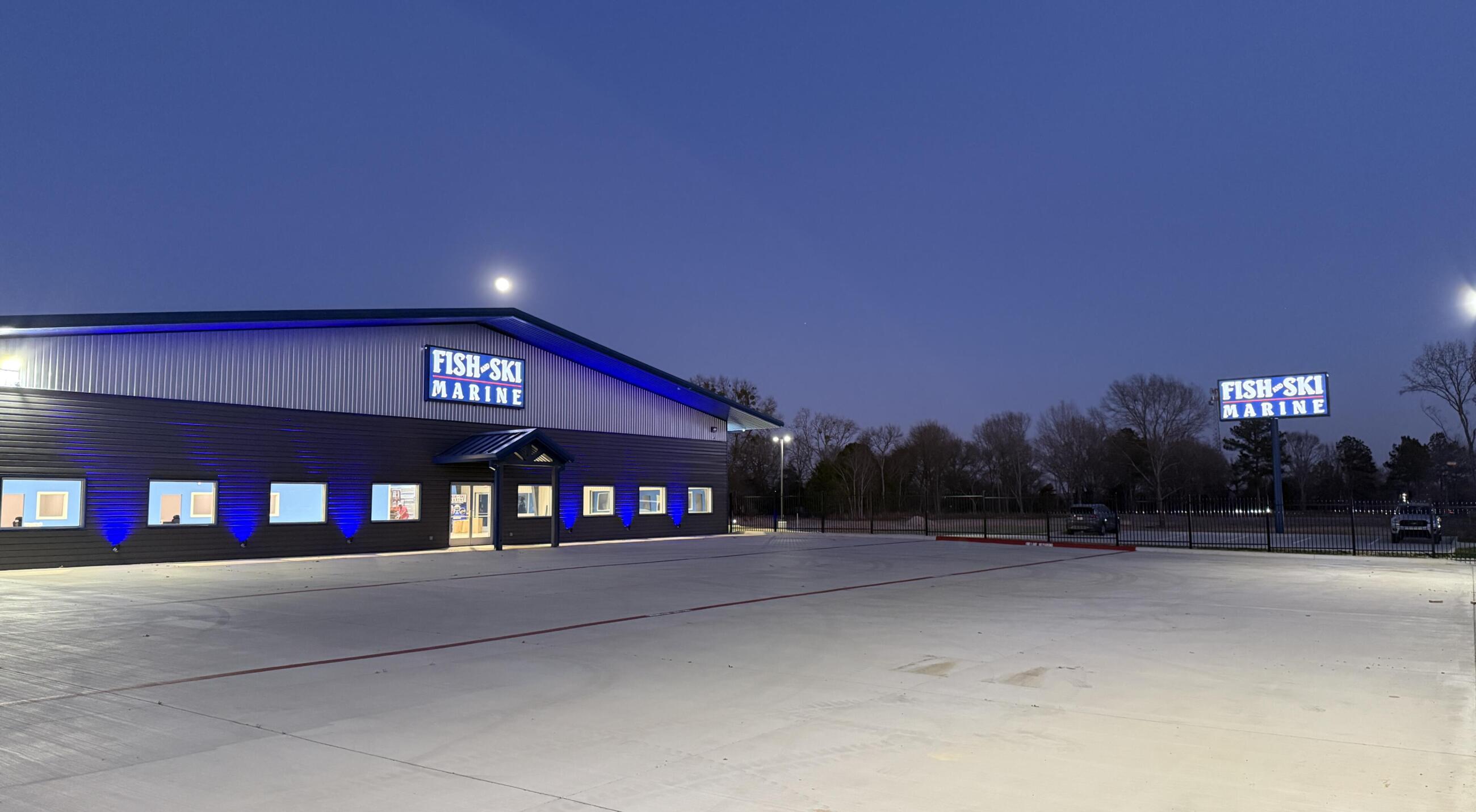 Fish-Ski Marine dealership storefront with blue lighting at dusk in Canton, Texas