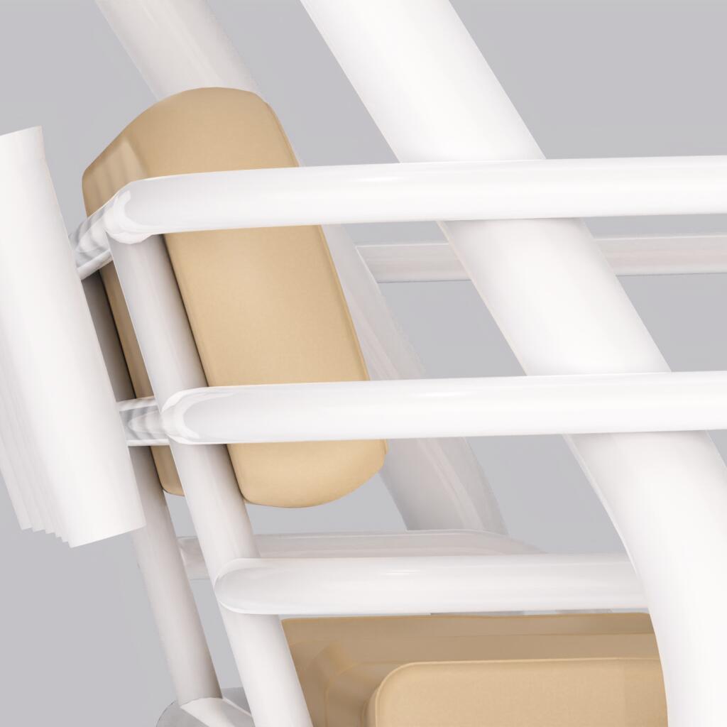 Close-up of white helm seating with tan cushions and overhead white frame structure