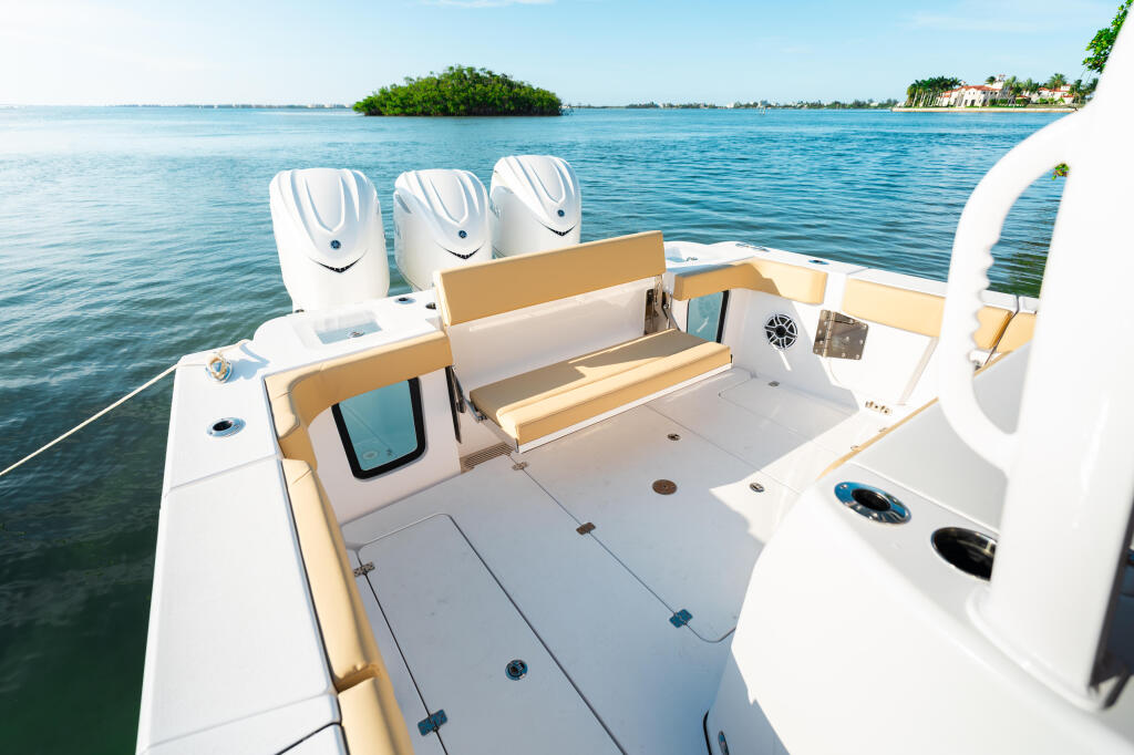 Open 352 center console boat with white hull, tan accents, three outboard engines, and spacious deck with seating