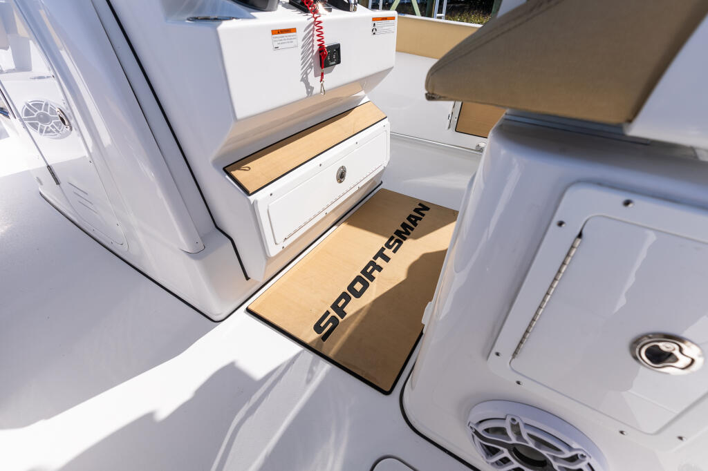 Sportsman center console cabin interior with padded footrest, storage compartments, and helm seating area