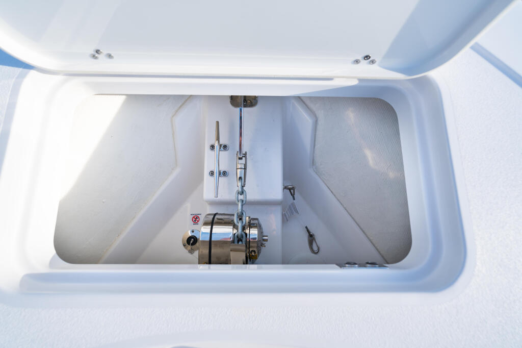 Open livewell compartment with drain, through-hull fitting, and stainless steel hardware visible from above