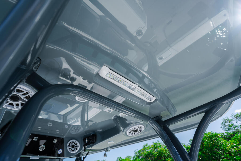 Hard-top canopy with LED lighting strips and open helm console visible below
