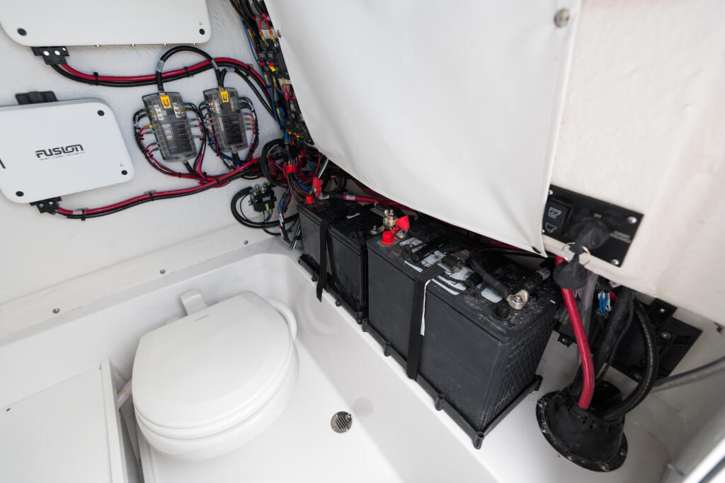 Dual battery system with Fusion amplifier and red wiring in center console engine compartment