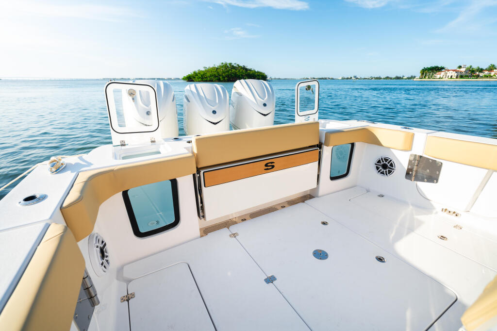 Open 352 center console boat cockpit with tan and white seating facing calm blue water