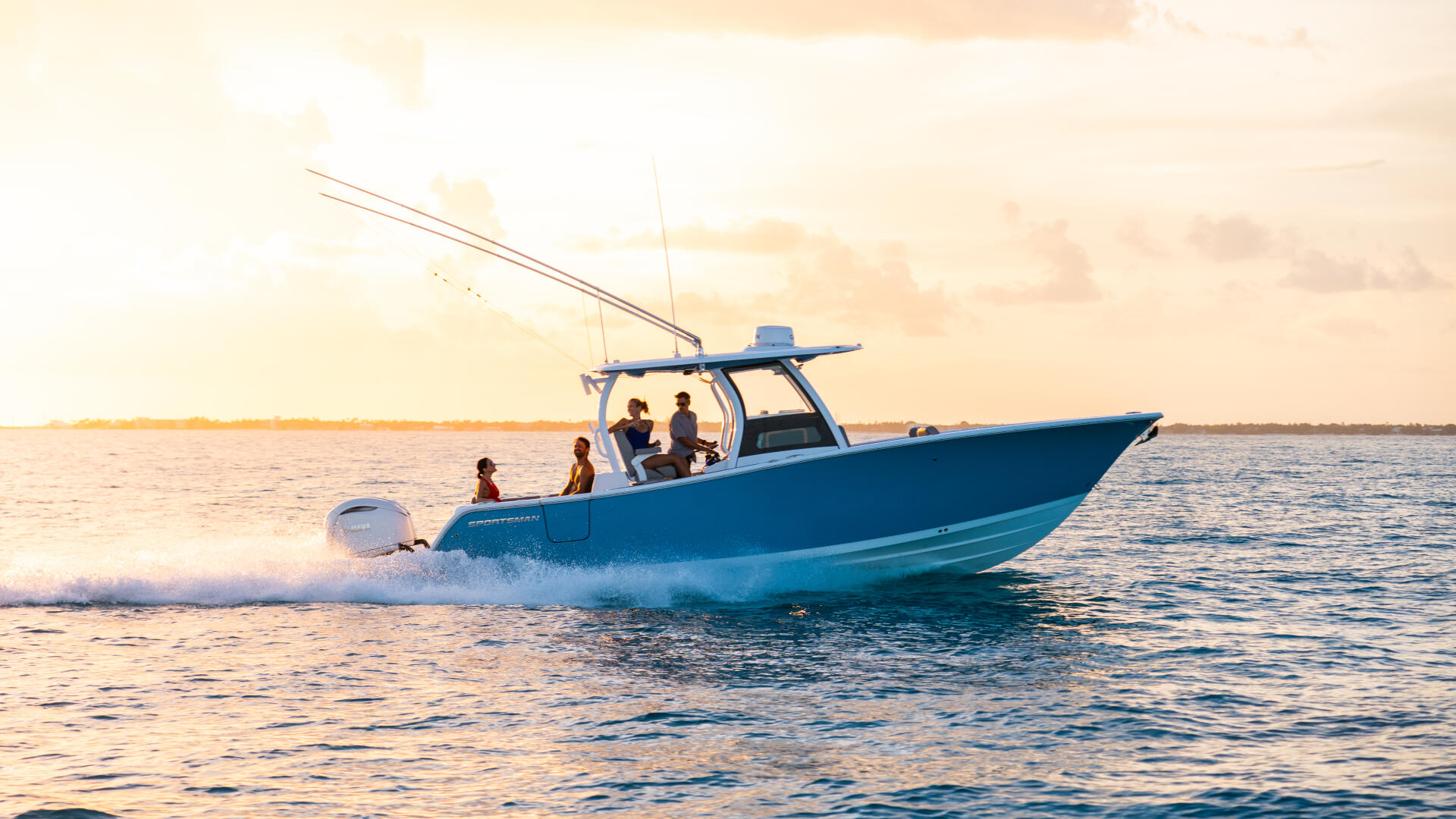 Blue center console fishing boat with passengers running through shallow coastal waters at sunset