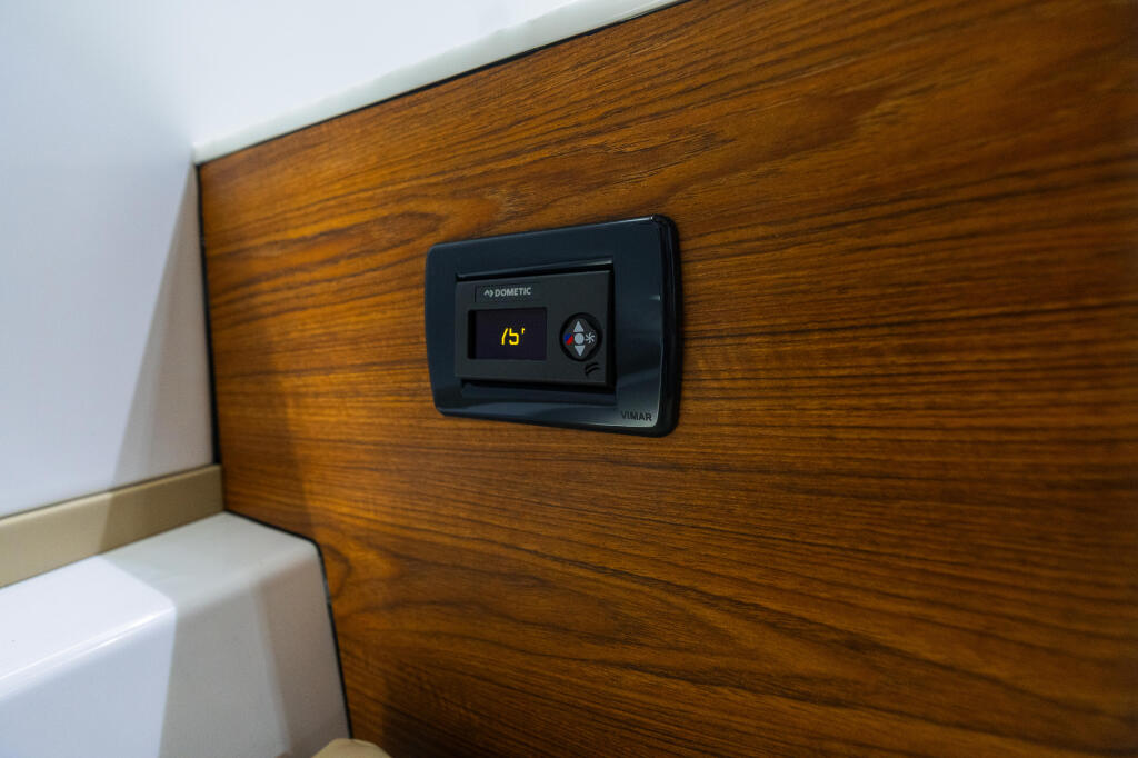 Dometic climate control panel mounted on wood-grain cabin wall