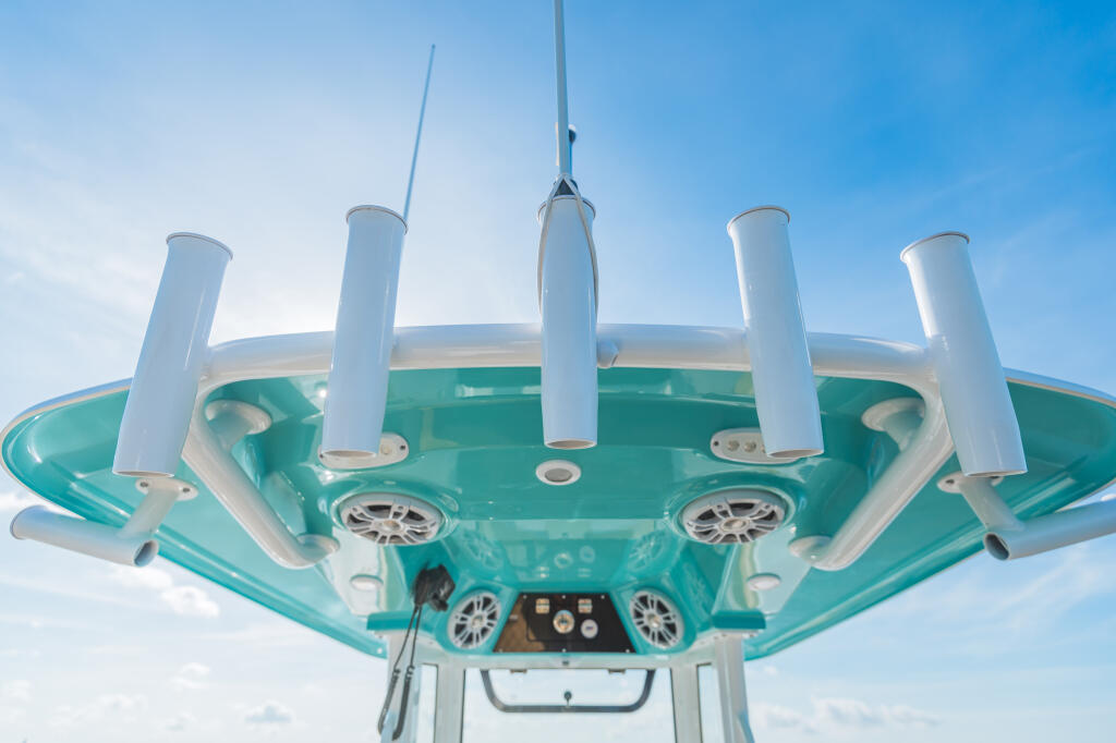 Underside view of turquoise hard-top with white radar arch, antennas, and speakers mounted above
