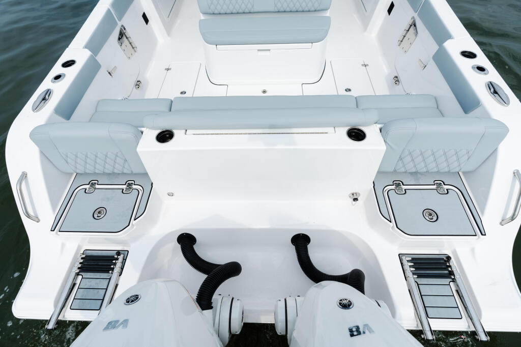 Overhead view of fishing boat cockpit with dual helm seating, center console, and dual engine controls