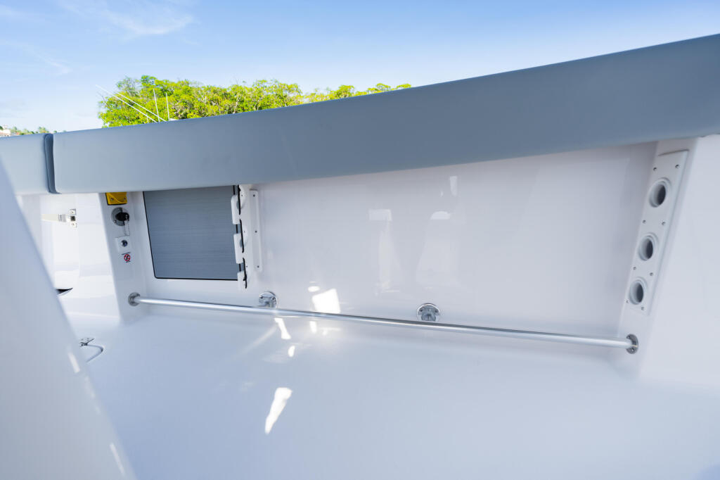Open 322 boat cockpit with white fiberglass, control panel, and bimini top