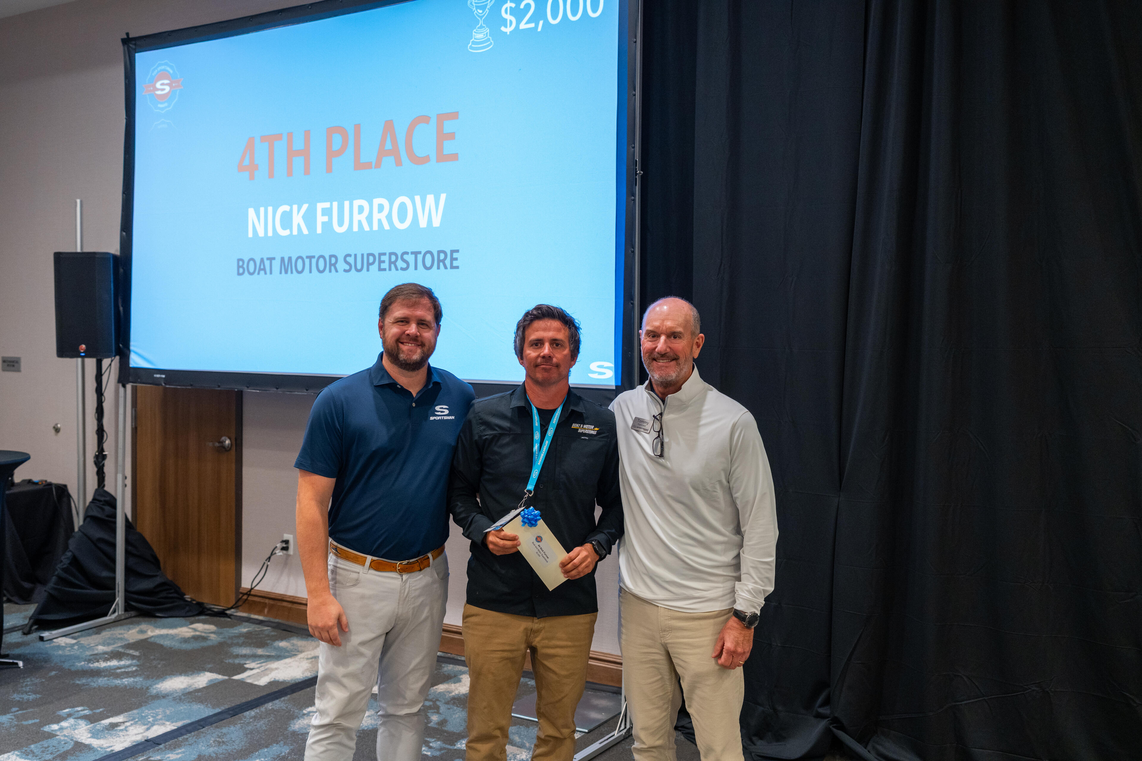 Nick Furrow accepts a 4th place award of $2,000 at a boat industry sales training event