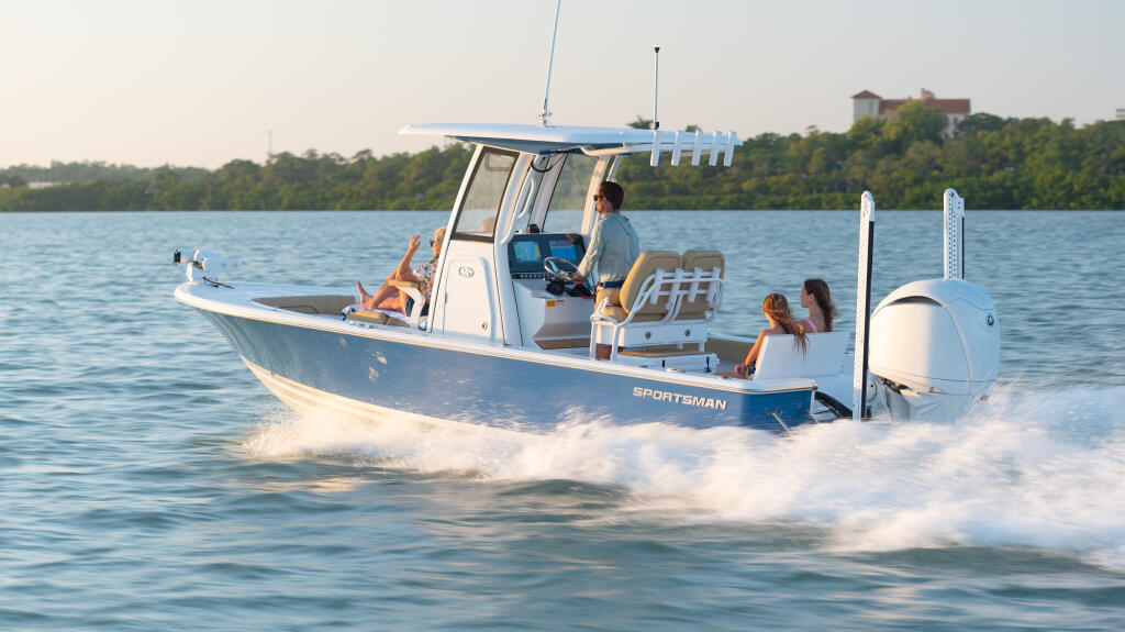 Sportsman center console boat running through shallow beach waves with passengers aboard