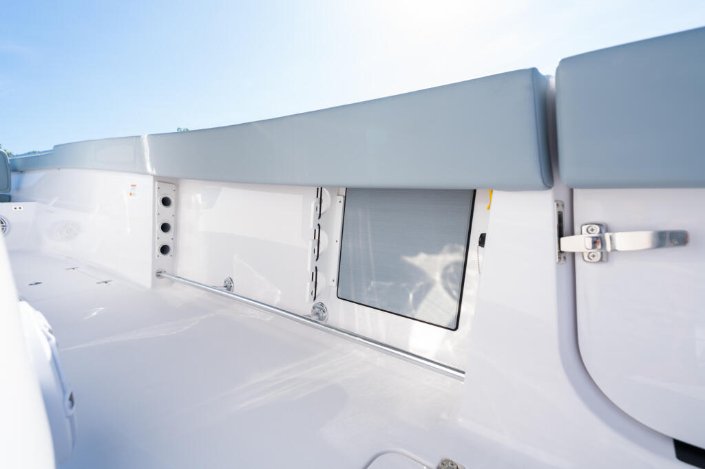 Open boat cabin exterior with canvas hard-top and side window access door in bright sunlight