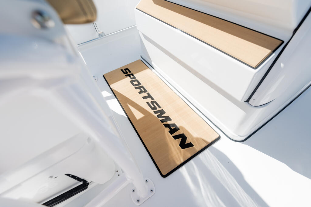 Open SportSman branded teak anti-fatigue helm pad installed on boat deck