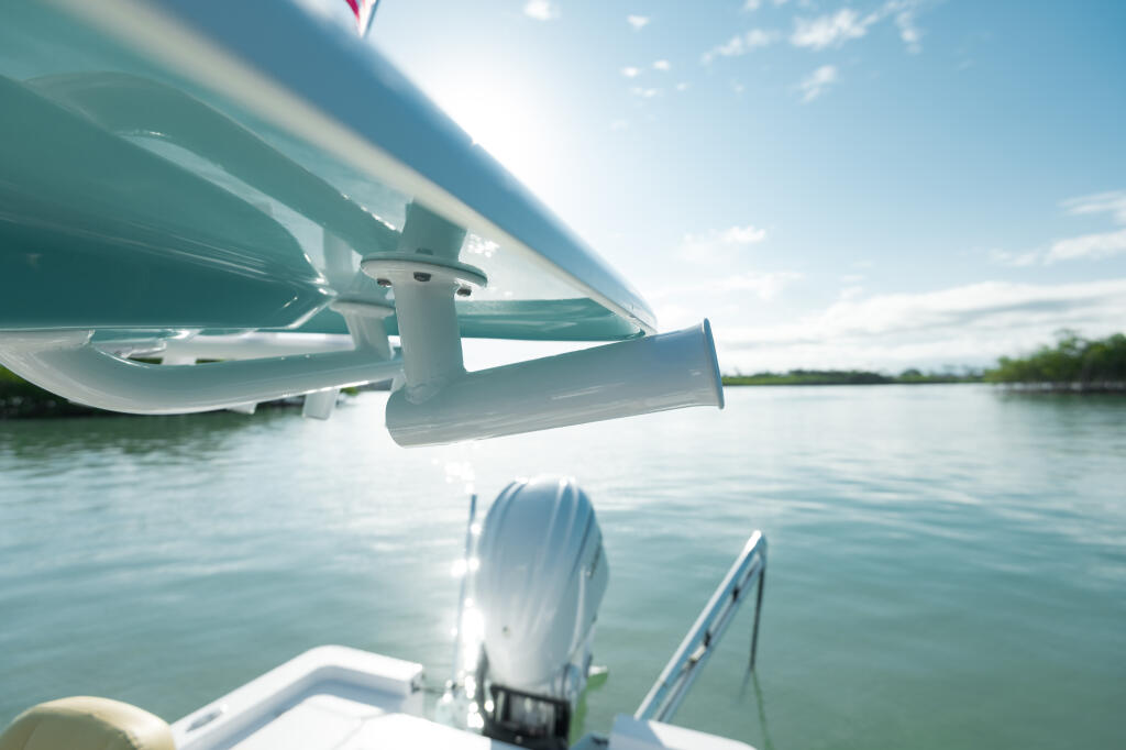 Boat's trolling motor and anchor system mounted on the bow over calm water