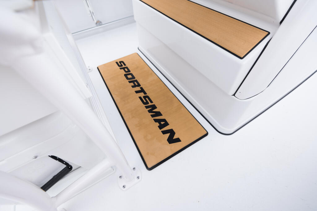 Overhead view of boat deck with tan and black "Sportsman" branded anti-fatigue mats at the helm station