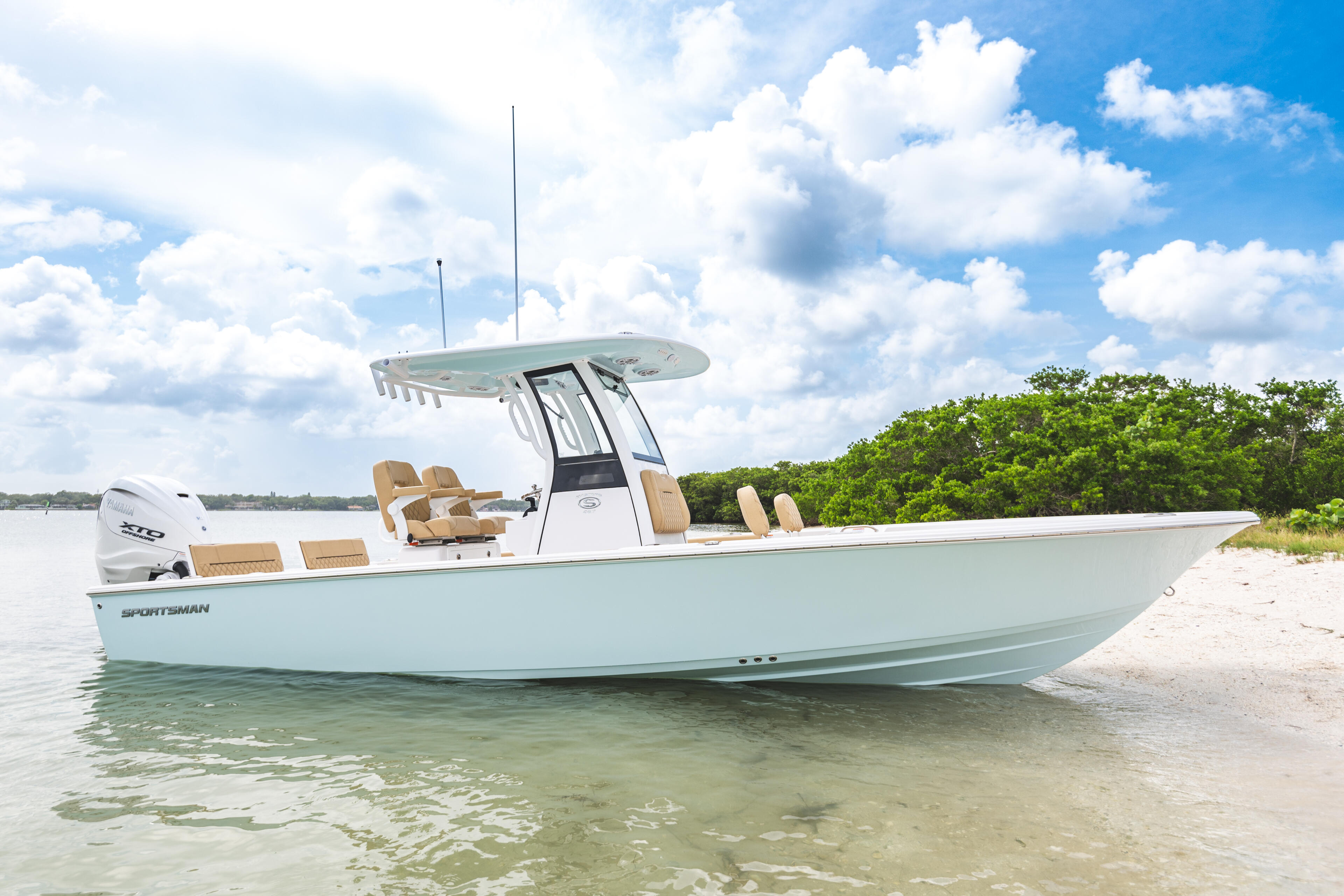 Sportsman center console boat beached in shallow turquoise water with hard-top and tan seating