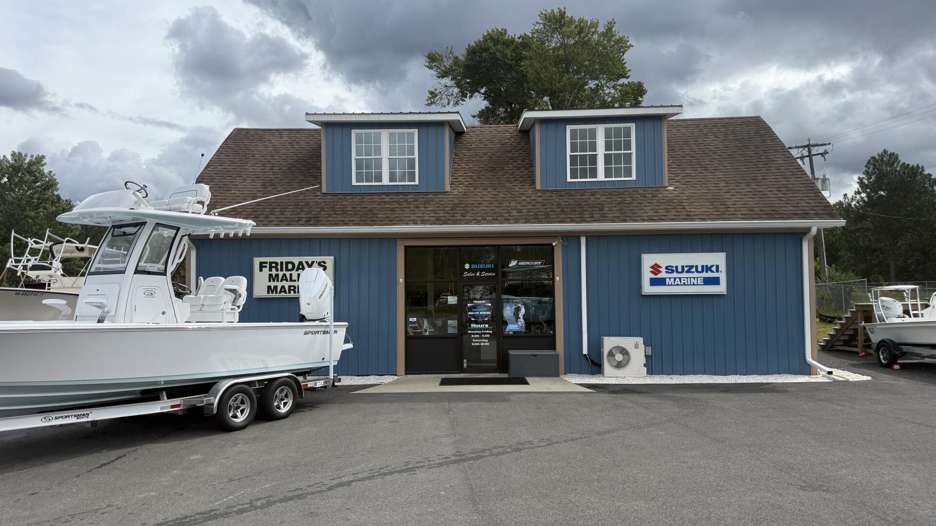 Friday's Mali Mari boat dealership with Suzuki Marine signage and boats on display and trailer