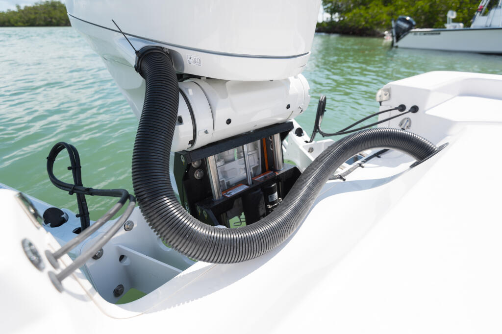 Outboard engine with integrated GPS display and steering system mounted on center console fishing boat