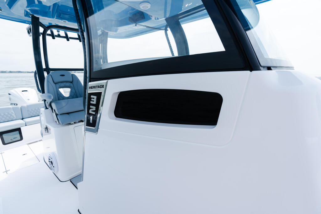 Heritage 321 center console helm with hard-top canopy and clear windshield overlooking open water
