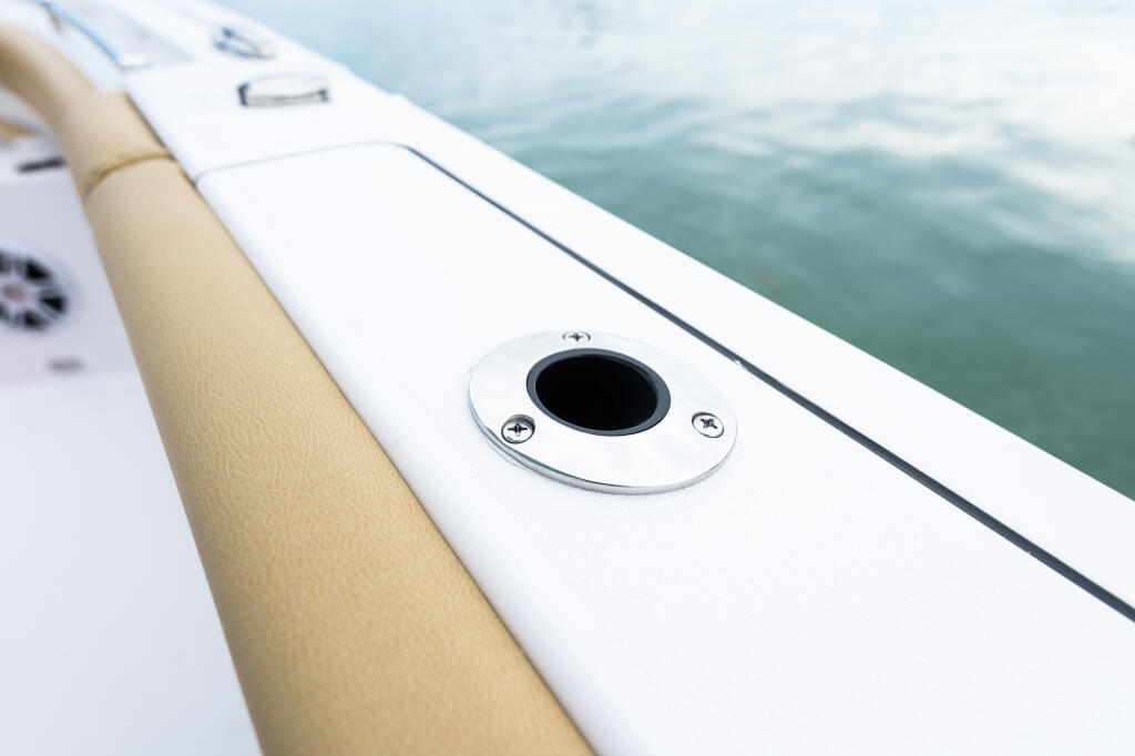Flush-mount gunwale rod holder on boat gunwale with water in background