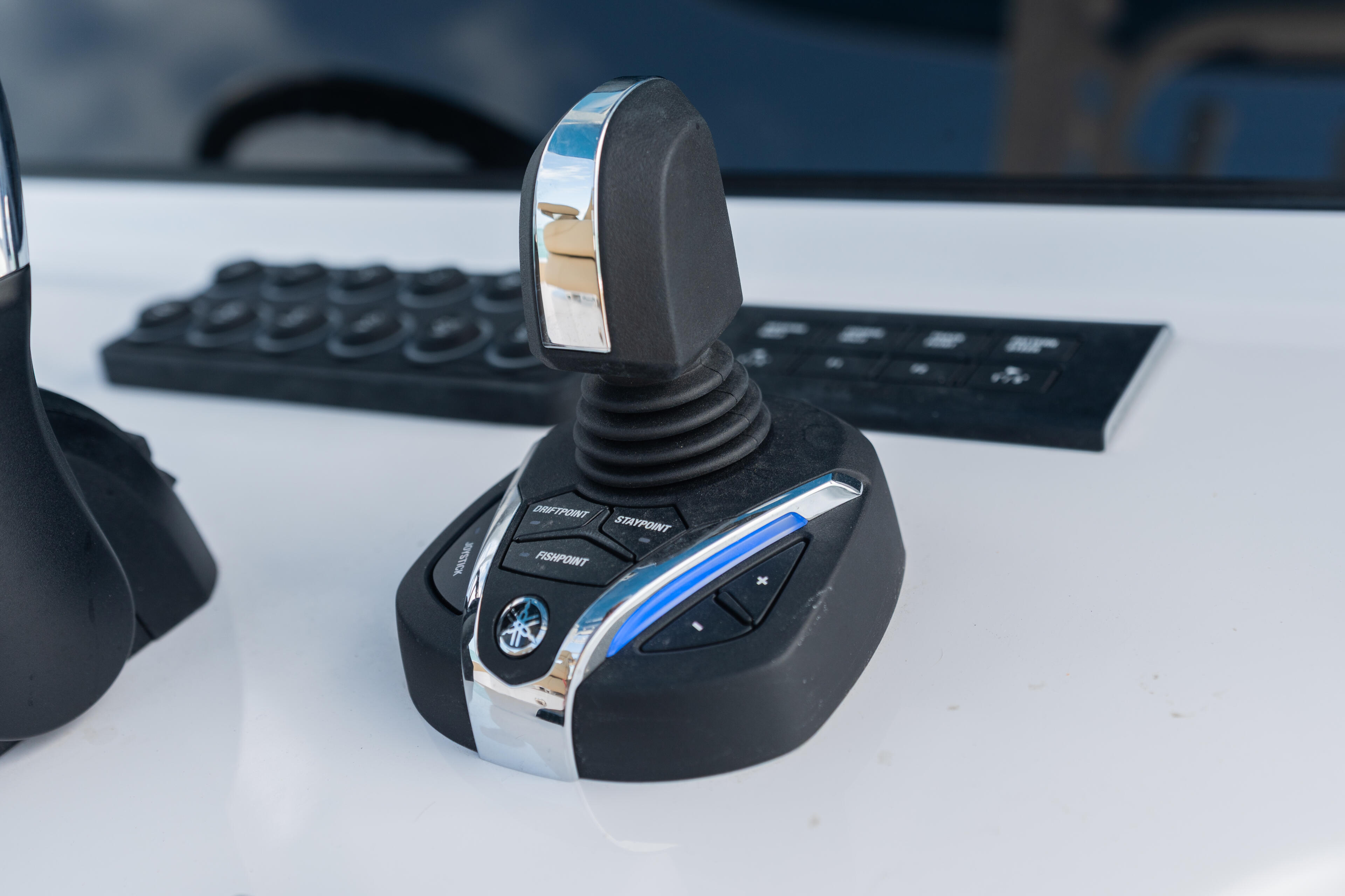 Yamaha boat helm joystick controller with blue accent stripe and chrome details on white console