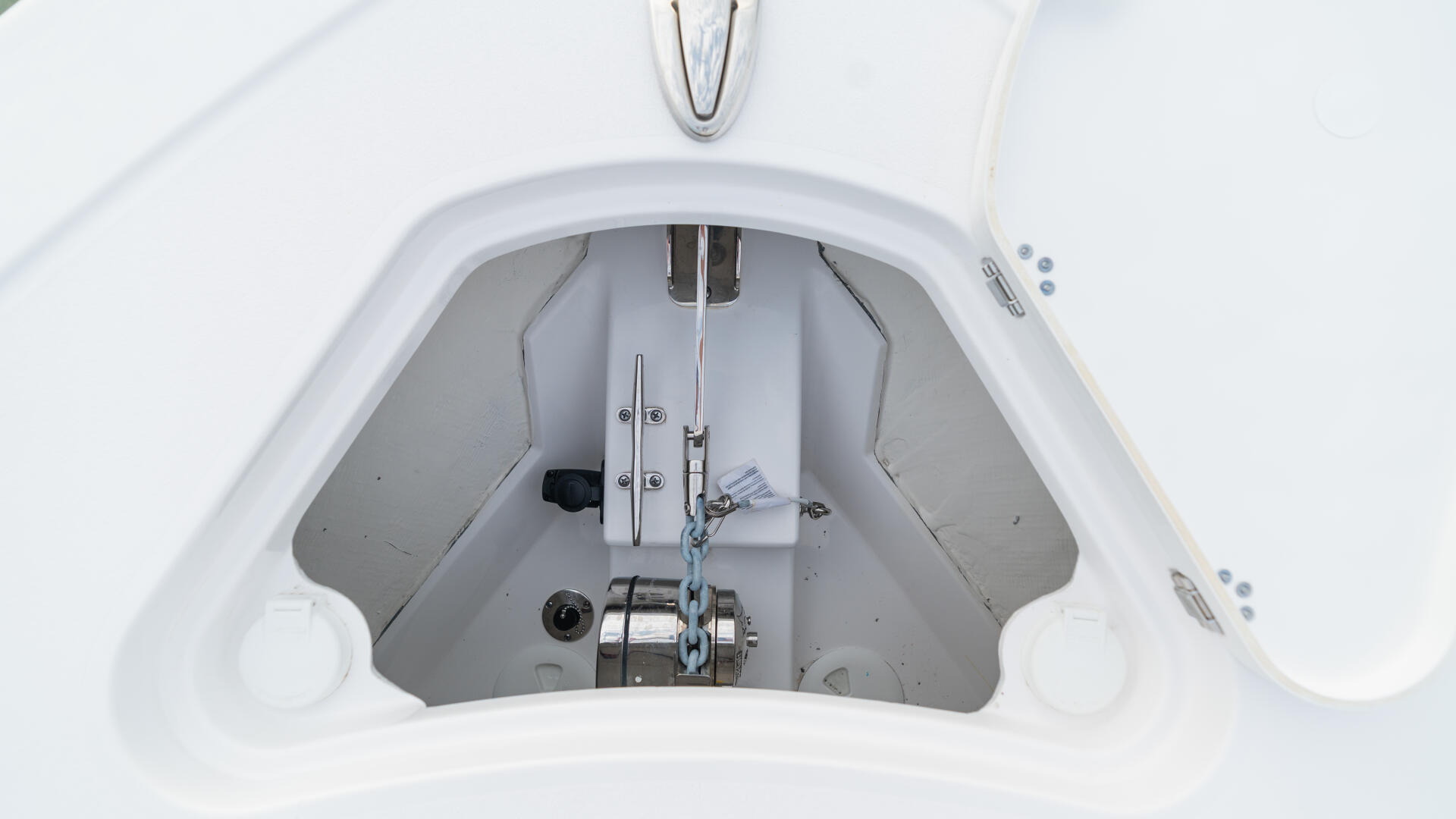 Overhead view of boat helm station showing steering wheel, control levers, and instrument panel