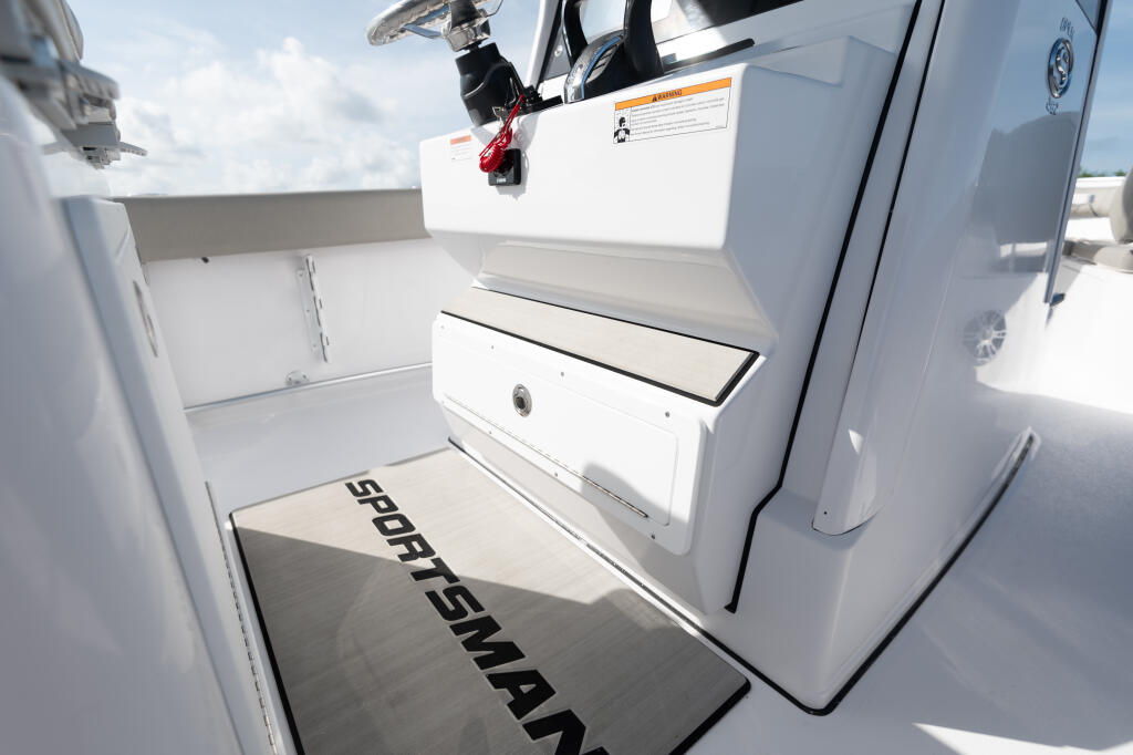 Open center console boat with storage compartment and anti-fatigue helm pad in bright sunlight