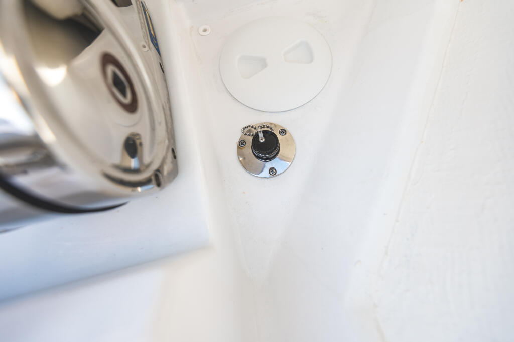 Stainless steel freshwater washdown control valve mounted on white boat hull