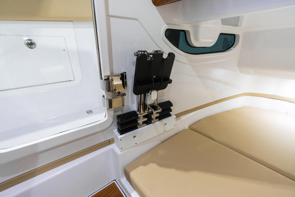 Cabin interior showing cream seating, storage compartments, and tinted window with gold trim accents