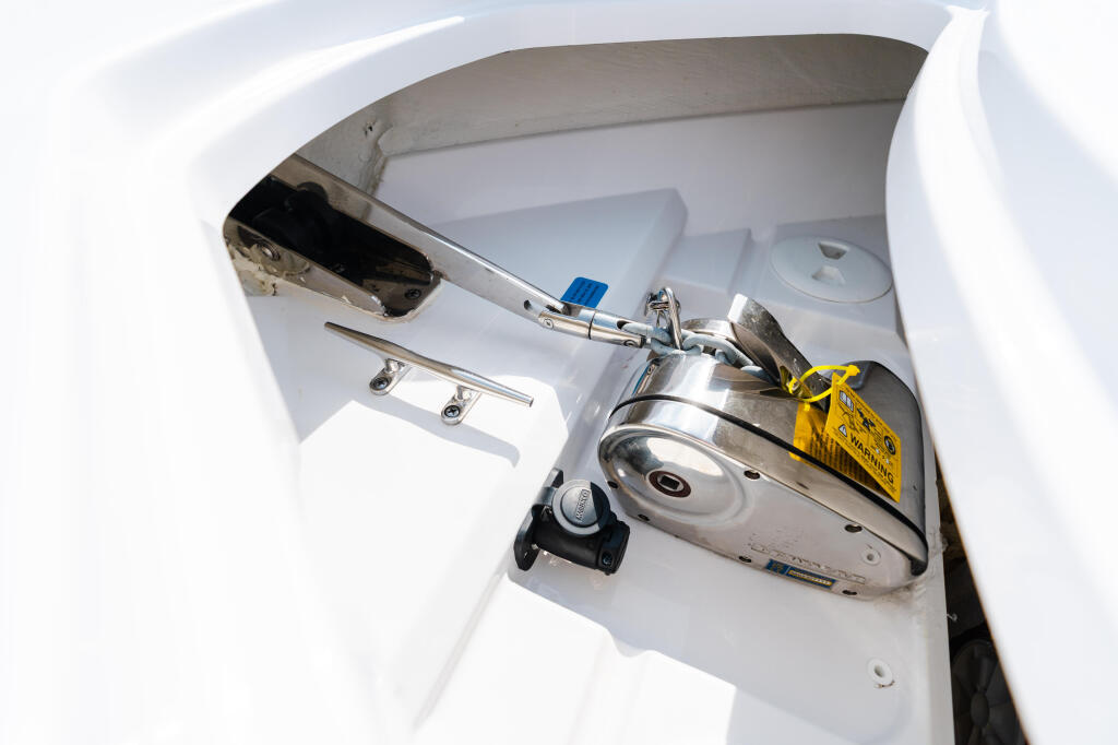 Overhead view of boat console with polished stainless steel helm station and yellow safety tag