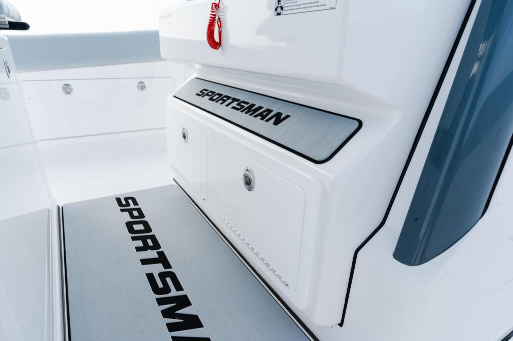Sportsman branded transom and swim platform with storage compartments on white boat hull